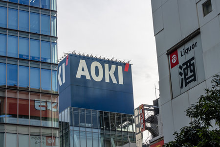 Tokyo, Japan, November 6 2023: Urban landscape with AOKI fashion store and LIQUOR signageのeditorial素材