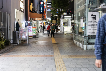 Tokyo, Japan, November 6, 2023: Nighttime Street Scene in Bustling Shopping Districtのeditorial素材
