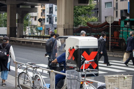Tokyo, Japan, November 6 2023: Delivery Worker in Urban Settingのeditorial素材