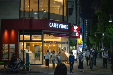 Tokyo, Japan, November 6 2023: Night Scene at Caffe Veloce with Pedestriansのeditorial素材