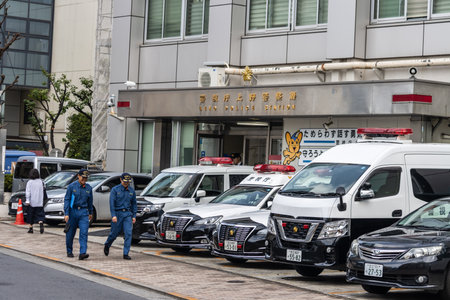 Tokyo, Japan, November 6 2023: Police Station Exterior with Officers and Patrol Carsのeditorial素材