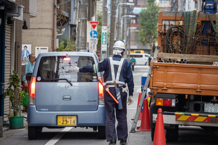Tokyo, Japan, November 6, 2023: Traffic Control on Urban Streetのeditorial素材