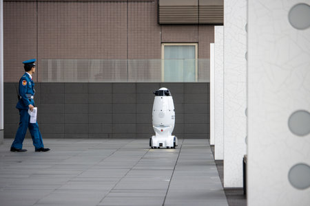 Tokyo, Japan, November 6, 2023: Security Robot and Police Officer on Patrolのeditorial素材