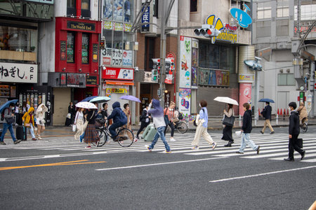 Tokyo, Japan, November 6 2023: Bustling City Street with Pedestrians and Cyclistsのeditorial素材
