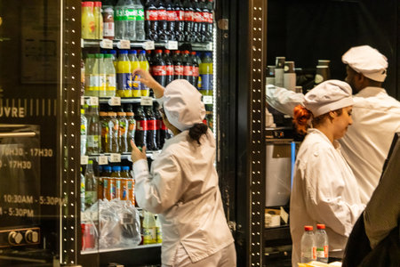 Le Louvre, France, November 9, 2023: Chefs Restocking Beverages in Cafe