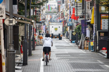 Tokyo, Japan, November 6, 2023: Cyclist on Urban Streetのeditorial素材