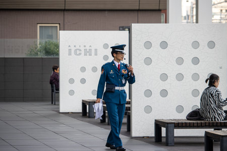 Tokyo, Japan, November 6, 2023: Security guard communicating via radio