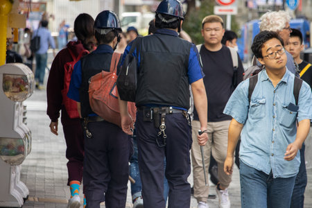 Tokyo, Japan, November 6, 2023: City Police Patrol Among Pedestrians
