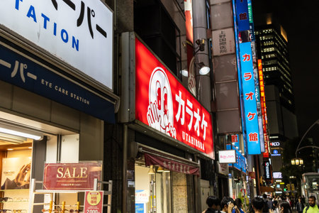Tokyo, Japan, November 6, 2024: Night View of Busy Shopping Street with Illuminated Signboardsのeditorial素材