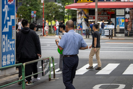Tokyo, Japan, November 6, 2024: Pedestrians and Urban Street Life near Anime Storeのeditorial素材