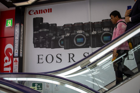 Tokyo, Japan, 6 November 2024: Canon advertisement in a public space with passersby