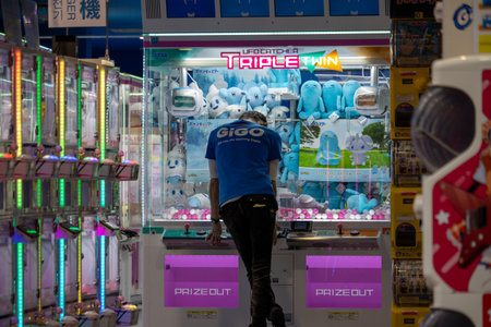 Tokyo, Japan, November 6, 2024: Arcade Game Center with Claw Machines and Visitorsのeditorial素材