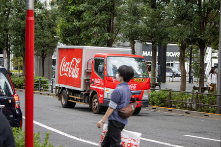 Tokyo, Japan, November 6, 2024: Coca-Cola Delivery Truck on Urban Streetのeditorial素材