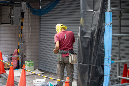 Tokyo, Japan, November 6, 2024: Construction Worker on Urban Building Siteのeditorial素材