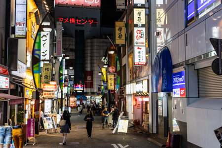 Tokyo, Japan, November 7, 2024: Bustling Nighttime Street in Urban Tokyoのeditorial素材
