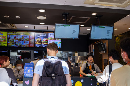 Tokyo, Japan, November 7, 2024: Customers Ordering at a Fast Food Restaurant Counterのeditorial素材