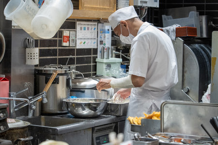 Tokyo, Japan, November 7, 2024: Professional Chef Cooking in a Restaurant Kitchenのeditorial素材