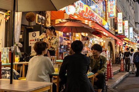 Tokyo, Japan, November 7, 2024: Nightlife Scene with Locals Dining at Street Restaurantのeditorial素材