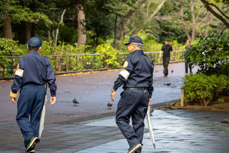Tokyo, Japan, November 7, 2024: Security Personnel Patrolling in Park