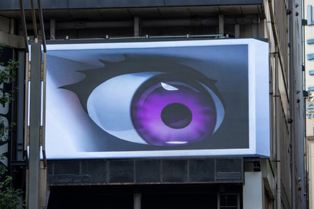 Tokyo, Japan, November 7, 2024: Close-up of Eye-Themed Graphic on Urban Billboardのeditorial素材