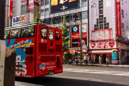 Tokyo, Japan, November 7, 2024: Red Hop-On Hop-Off Sightseeing Bus in Urban Streetのeditorial素材