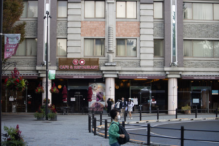 Tokyo, Japan, November 7, 2024: Urban Street Scene with CafÃ© and Pedestriansのeditorial素材