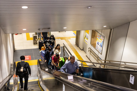 Tokyo, Japan, November 7, 2024: Commuters on Escalator in Busy Subway Stationのeditorial素材