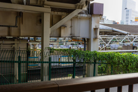 Tokyo, Japan, November 7, 2024: Urban Train Station Structure with Greeneryのeditorial素材