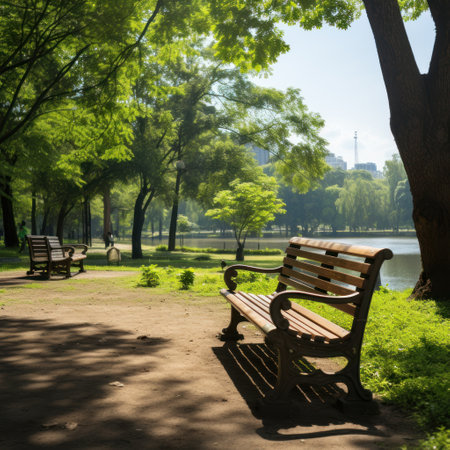 Urban green recreation area, park with benches and lake, shady paths along the river or lakeの素材