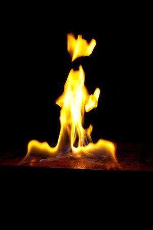 tongues of fire on a dark backgroundの写真素材