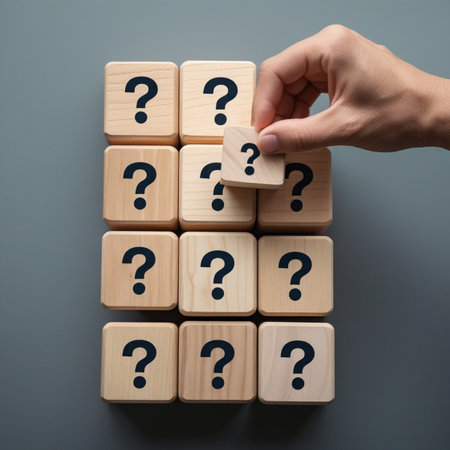 Hand of man arranging wooden cube with question mark on gray background.の素材