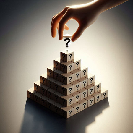 Conceptual image of human hand putting question mark on pyramid of wooden cubesの写真素材