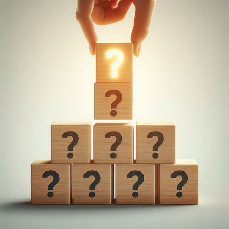 Conceptual image of human hand on wooden cubes with question mark symbolの写真素材