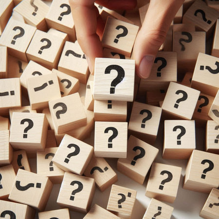 Businessman hand arranging wooden cube with question mark symbol on top.の写真素材