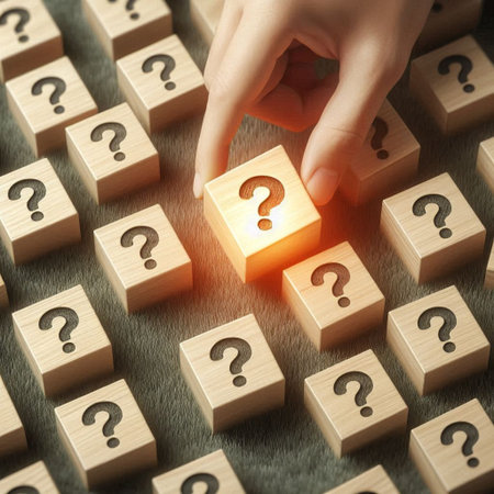 Close up of human hand placing wooden cube with question mark on top.