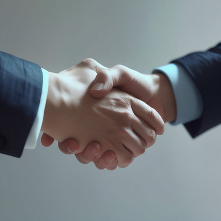 Closeup of business people shaking hands on gray background. Success concept