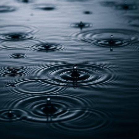 Water drop on water surface with ripples and ripples. Abstract background.の写真素材