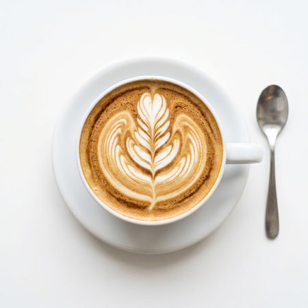 Coffee cup with latte art on white background, top view