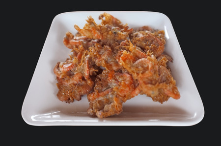 Batter-fried prawns, Shrimp fried in batter, Tempura in Thai style, white dish isolated on black backgroundの写真素材