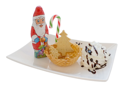 Ice cream in wafer cone / bowl with christmas decoration isolated on white backgroundの写真素材