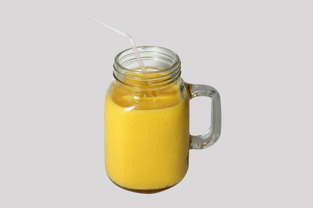 Mango smoothies in glass mugの写真素材