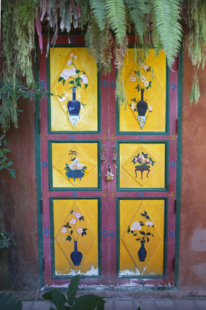 Oriental style , Colorful paint door  decorated plants corner in old house , Beautiful background , space for textの写真素材