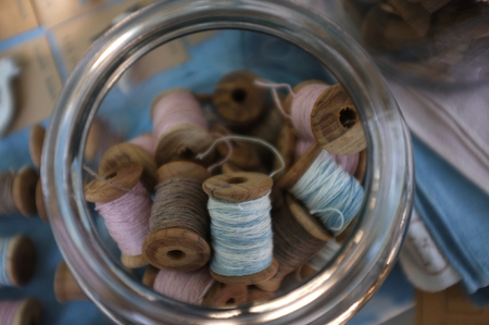 Wooden reels in Glass Jar , Concept handy craft backgroundの写真素材