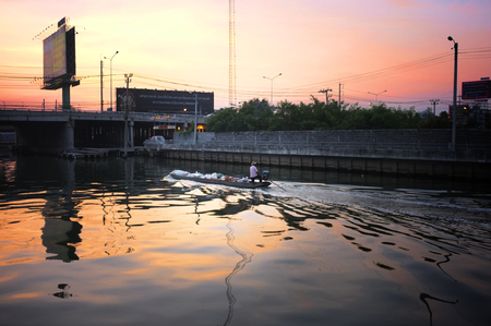 Long tail boat to travel along on the canal Khlong Prawet Buri Rom , Bangkok , Thailand in sunriseのeditorial素材