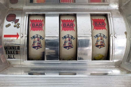 Slot machine showing three golden bell symbols . Concept luckyの写真素材