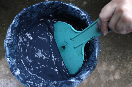 Traditional process of making indigo dye, Indigo cake in plastic bagの写真素材