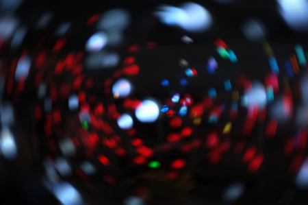 Blurred LED screen closeup. Glowing threads in a color spectrum on a black background. 