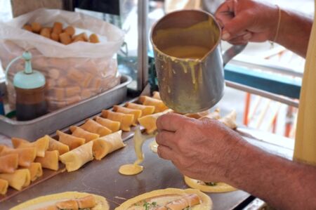 The man cooking Soft Waffle ,  Roll pancake stuffed with pork with custard and eeg ,Thai dessert.の写真素材