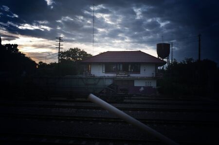 A colorful sunup above a small train station in thailand の写真素材