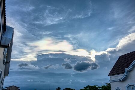 Rainbow beams over clouds on blue sky blackgroundの写真素材